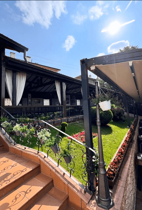 Hanging greenery and flowers along the pergola terrace