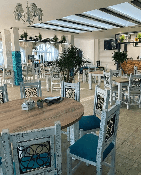 The restaurant's signature teal vintage dining chairs